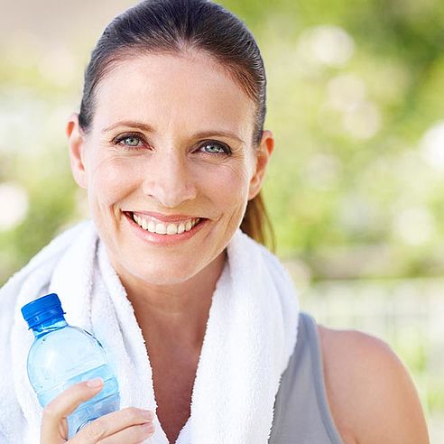 Woman with a drinks bottle doing sport
